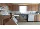 An unfinished kitchen with wood cabinets and marble-style backsplash is awaiting updates at 6405 2Nd Palm Pt, St Pete Beach, FL 33706