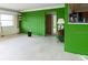 The bright living room features unique green-tiled accent walls and an open floor plan, great for entertaining at 6405 2Nd Palm Pt, St Pete Beach, FL 33706