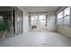 Sunroom with sliding glass doors and paneled walls features bright sunlight and peaceful view at 6405 2Nd Palm Pt, St Pete Beach, FL 33706