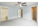 Inviting bedroom with attached bathroom, neutral carpet, and walk-in closet at 7410 E Bank Dr, Tampa, FL 33617