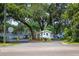 Gated community entrance with mature landscaping and security booth ensuring privacy and security at 7410 E Bank Dr, Tampa, FL 33617