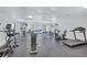 A fully-equipped gym area with modern machines, weights, and mirrors on the walls at 7410 E Bank Dr, Tampa, FL 33617