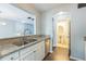 Granite countertop kitchen with view to open living room and powder bath at 7410 E Bank Dr, Tampa, FL 33617
