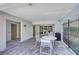 Covered patio area with outdoor seating, tables, and tiled flooring, perfect for relaxing at 7410 E Bank Dr, Tampa, FL 33617
