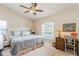 Comfortable bedroom with neutral paint, a ceiling fan, and an arched window with natural light at 8549 Pinafore Dr, New Port Richey, FL 34653
