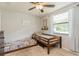 Bright bedroom with two twin beds, natural lighting from the window, and a light colored carpeted floor at 8549 Pinafore Dr, New Port Richey, FL 34653