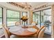 Bright dining area features a wood table and views to the screened in porch at 8549 Pinafore Dr, New Port Richey, FL 34653