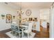 Dining room features a decorative table with seating for six, chandelier, and hardwood floors at 8549 Pinafore Dr, New Port Richey, FL 34653