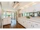 Well-lit kitchen with white cabinets, stainless steel appliances, countertop space and a dining area at 8549 Pinafore Dr, New Port Richey, FL 34653