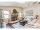 Bright living room showcasing fireplace, vaulted ceilings, wood floors and neutral colors at 8549 Pinafore Dr, New Port Richey, FL 34653