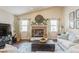 Cozy living room featuring a brick fireplace, vaulted ceilings, and natural lighting at 8549 Pinafore Dr, New Port Richey, FL 34653