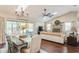 Open living and dining room area features a fireplace, beamed ceilings, and skylights at 8549 Pinafore Dr, New Port Richey, FL 34653