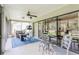 The screened-in porch features comfortable seating, a ceiling fan, and serene views of the outdoors at 8549 Pinafore Dr, New Port Richey, FL 34653