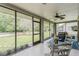 A cozy screened-in porch offers views of the backyard and has room for outdoor dining and relaxation at 8549 Pinafore Dr, New Port Richey, FL 34653