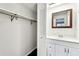 Bathroom featuring a single sink vanity, white cabinets, and mirror at 9142 Oakwood Ln, Seminole, FL 33776