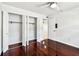 Bedroom with hardwood floors, a ceiling fan, and spacious closet at 9142 Oakwood Ln, Seminole, FL 33776