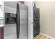 Stainless steel refrigerator and stacked washer/dryer in a modern utility area at 962 Sombra St, Tampa, FL 33619