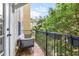Relaxing balcony space with outdoor seating and a lush green view at 962 Sombra St, Tampa, FL 33619