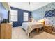 Cozy bedroom with blue walls, carpeted floor, and ample natural light at 962 Sombra St, Tampa, FL 33619