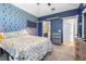 Comfortable bedroom featuring blue accent wall, soft carpet, and ample storage at 962 Sombra St, Tampa, FL 33619