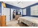 Well-lit bedroom with closet, carpet, tv, and two windows at 962 Sombra St, Tampa, FL 33619