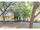 Two-story exterior showcasing the property's architecture and landscaping with mature trees at 962 Sombra St, Tampa, FL 33619