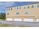 Exterior view of a three-story building with multiple garage doors on the ground floor at 962 Sombra St, Tampa, FL 33619