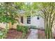 Charming front entrance with lush landscaping, bamboo, and a cozy, inviting doorway to this home at 962 Sombra St, Tampa, FL 33619