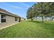 Expansive backyard with mature trees and white fencing defining the property line at 9724 Troncais Cir, Thonotosassa, FL 33592