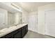 Large bathroom featuring dual sinks, granite countertops, and a glass door shower at 9724 Troncais Cir, Thonotosassa, FL 33592