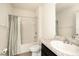 Bright bathroom featuring a shower-tub combo, sleek vanity, and neutral tile flooring at 9724 Troncais Cir, Thonotosassa, FL 33592