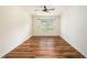 A bedroom featuring laminate floors, a ceiling fan, and a bright window at 9724 Troncais Cir, Thonotosassa, FL 33592