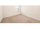 Bright bedroom featuring neutral carpet, white walls, and a window providing natural light at 9724 Troncais Cir, Thonotosassa, FL 33592