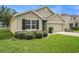 Well-maintained single Gathering home with a two-car garage, lush landscaping and inviting curb appeal at 9724 Troncais Cir, Thonotosassa, FL 33592