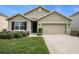 Charming single-Gathering home with manicured lawn and a two-car garage on a sunny day, perfect for suburban living at 9724 Troncais Cir, Thonotosassa, FL 33592