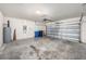 Spacious two-car garage with visible mechanics, perfect for storage and vehicles at 9724 Troncais Cir, Thonotosassa, FL 33592