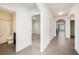 Bright hallway with tile flooring, leading to bedrooms and a bathroom with modern fixtures at 9724 Troncais Cir, Thonotosassa, FL 33592
