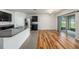 Open kitchen features granite countertops, stainless steel appliances, and sliding glass doors to the backyard at 9724 Troncais Cir, Thonotosassa, FL 33592