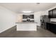 Bright kitchen features gray countertops, stainless steel appliances, and large center island at 9724 Troncais Cir, Thonotosassa, FL 33592