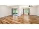 A bright living room featuring hardwood flooring, a ceiling fan and a sliding glass door at 9724 Troncais Cir, Thonotosassa, FL 33592