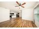 Bright and airy living room with hardwood flooring, ceiling fan, and natural light from the window at 9724 Troncais Cir, Thonotosassa, FL 33592