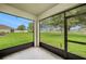 Screened in lanai showcasing a beautiful view of the spacious backyard with lush greenery at 9724 Troncais Cir, Thonotosassa, FL 33592