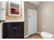 Cozy half bath with a modern vanity and tiled accents at 9752 Trumpet Vine Loop, Trinity, FL 34655