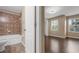 Bathroom with tiled shower and tub, and hardwood floor bedroom at 9752 Trumpet Vine Loop, Trinity, FL 34655