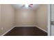 Empty bedroom with dark hardwood floors and neutral color palette at 9752 Trumpet Vine Loop, Trinity, FL 34655