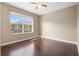 Bedroom with hardwood flooring and large window with backyard view at 9752 Trumpet Vine Loop, Trinity, FL 34655