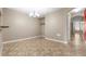 Dining room features tile flooring, neutral walls, and a modern chandelier at 9752 Trumpet Vine Loop, Trinity, FL 34655