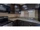 Kitchen featuring stainless steel appliances, granite countertops and espresso cabinets at 9752 Trumpet Vine Loop, Trinity, FL 34655