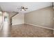 Spacious living room featuring tile flooring and a ceiling fan at 9752 Trumpet Vine Loop, Trinity, FL 34655