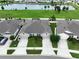 Aerial view of neighborhood homes overlooking well maintained lawns and a scenic lake at 10347 Heron Hideaway Loop, Land O Lakes, FL 34638
